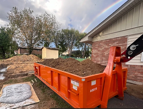 Contractor loading debris into rental dumpster in Danville, KY