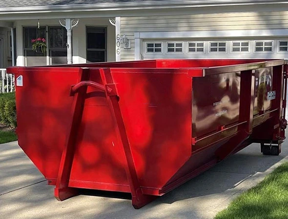 Contractor loading debris into rental dumpster in Danville, KY