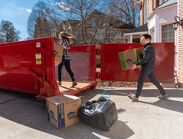 Contractor loading debris into rental dumpster in Lexington, KY