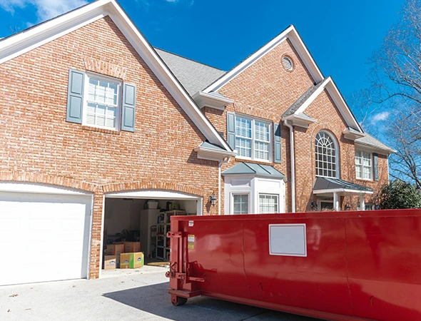 Roofing debris being loaded into rental dumpster in Winchester, KY